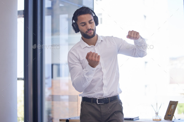 Businessman, headphones and dance to audio motivation in office for freedom or happiness. Man, musi