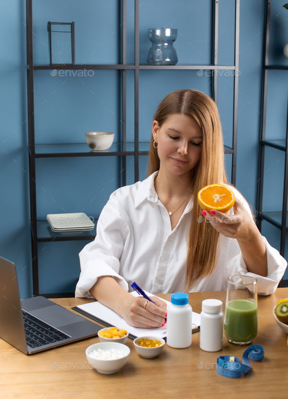 Specialist in dietetics advises an online client and makes an appointment for taking vitamins.  - Stock Photo - Images