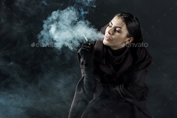 loyaliteit maag kofferbak woman in death costume smoking cigarette on black Stock Photo by  LightFieldStudios