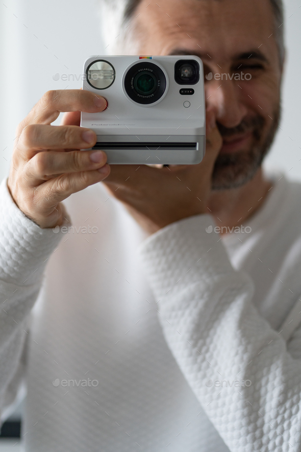 Man with Polaroid camera - Stock Photo - Images