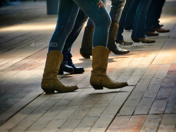 Western folk music dancer's legs in cowboy boots dancing on a wooden ...