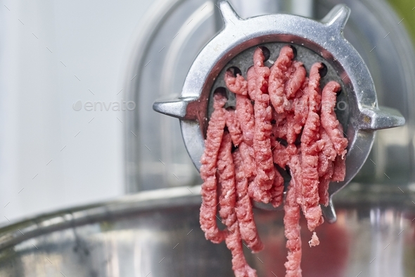 Freshly ground meat coming out of a meat grinder - Stock Image - F017/6580  - Science Photo Library