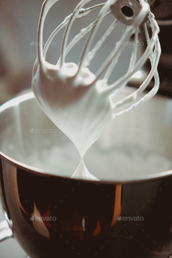 Close-up, whisking an egg white with small metal whisk