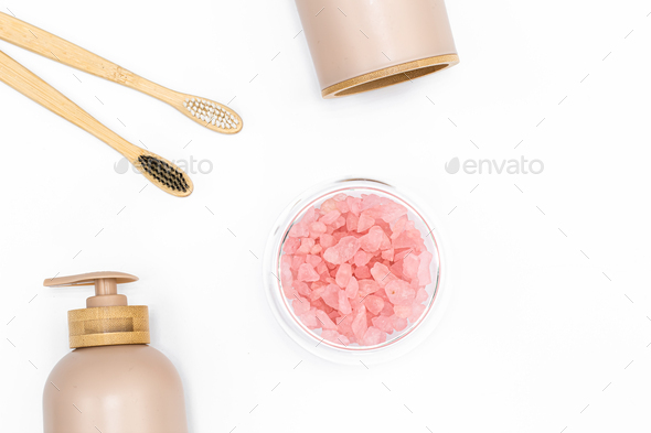 Spa composition with body care products on a white background, top view.