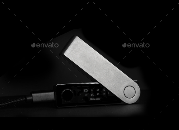 Cryptocurrency hardware wallet for safety storage of digital money isolated over black background - Stock Photo - Images