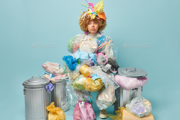 Shocked curly woman wants to live on clean Earth picks plastic litter to save environment being ecol