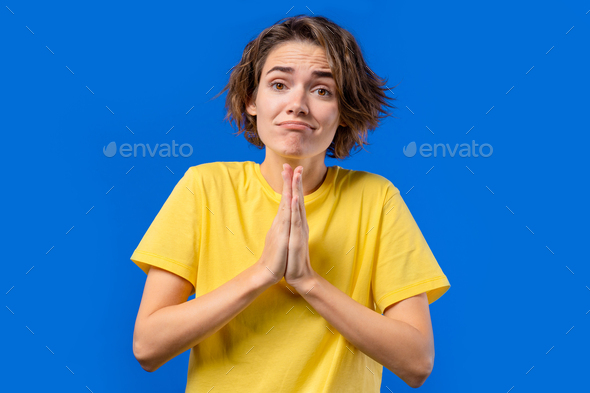 Guilty woman praying. Peace, love, harmony on blue background. Gratitude, religion concept.