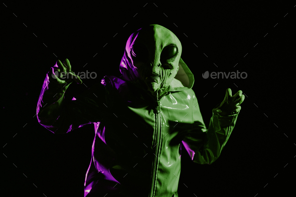 Futuristic alien showing frightening gesture, trying to scare. Creepy mask of humanoid planet