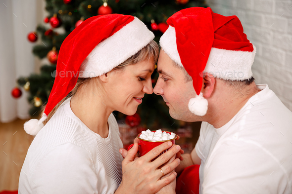 cute couple christmas tree, couple drinking hot chocolate under
