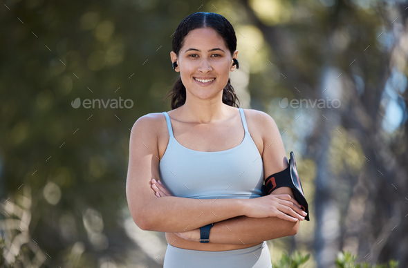 Portrait, exercise and woman, arms crossed and motivation in park with music, fitness and arm band.