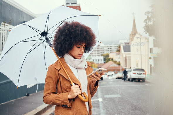 woman, umbrella and smartphone in city for social media content creation in autumn. Young influence