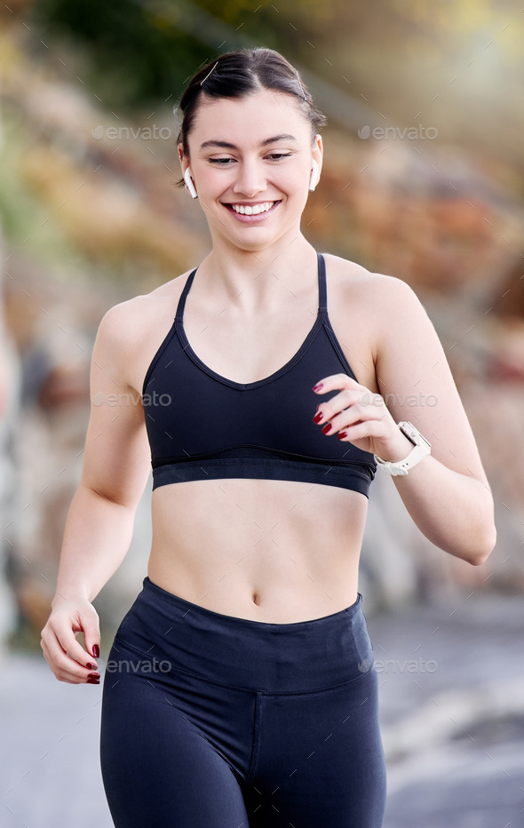Runner, fitness and woman running outdoor, bluetooth earphones for music or podcast and happy with