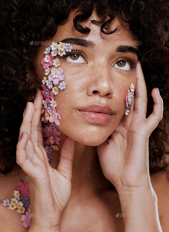 Model, makeup and beauty with flower eye for cosmetics, wellness and skin art on face in studio. Bl