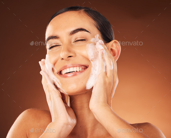 Skincare, hands and foam on face for cleaning with smile, happiness and spa wellness. Facial wash,