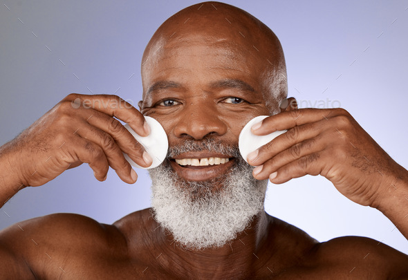 Skincare, facial cotton and senior black man on purple background in studio for beauty, wellness an