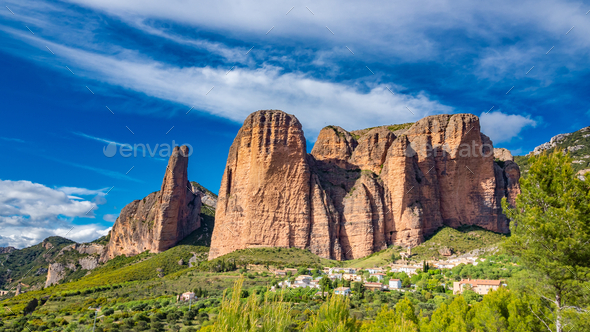 Scenic view of the famous rock formations of Mallos de Riglos in Spain under wispy sky background - Stock Photo - Images