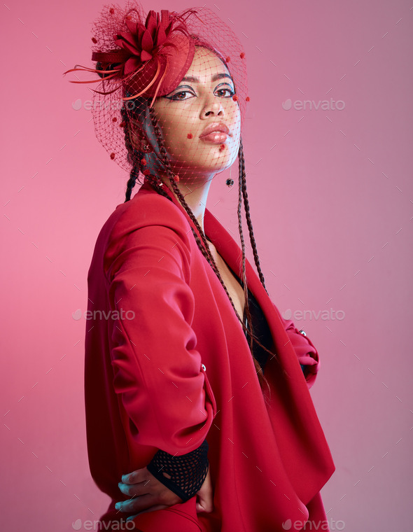 Woman, red fashion and edgy portrait, trendy and vintage wear in studio. Punk model, funky rock met