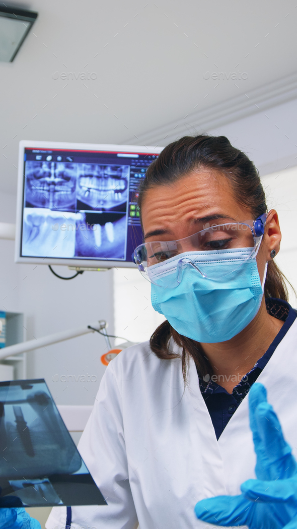 Patient pov in dental office explaining treatment of teeth cavit Stock