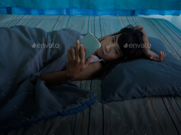 Woman Using Phone on Bed in Night at Home - Stock Photo - Images