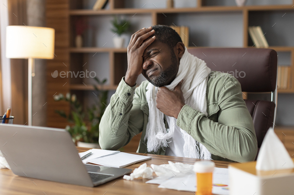 Despaired unhappy middle aged black businessman in scarf suffer from sore throat and high