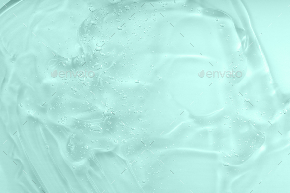 Cosmetic gel texture with bubbles background. Hyaluronic acid clear serum sample. Liquid green oil