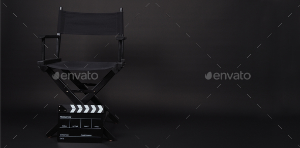 Black Clapperboard or movie slate with director chair on black background.