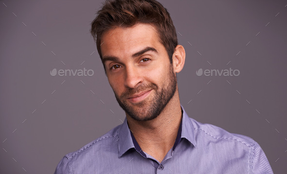 Rugged and manly. Studio shot of a handsome man against a gray background.