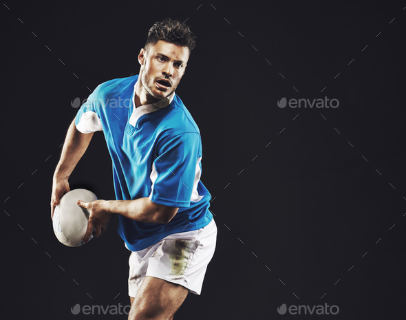 Time for a try. Studio shot of a rugby player passing the ball against a black background.