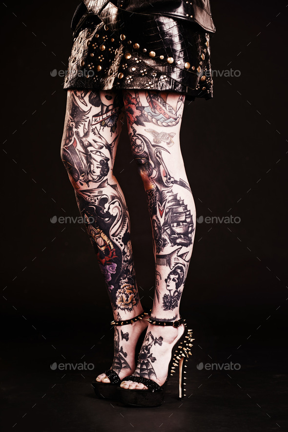 I own my style from head to toe. Studio shot of a womans tattooed legs.