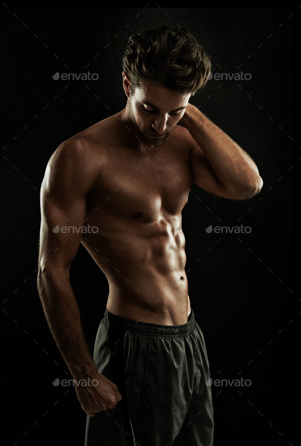 Dedication Super body. Gorgeous man with a sculpted body isolated on black.