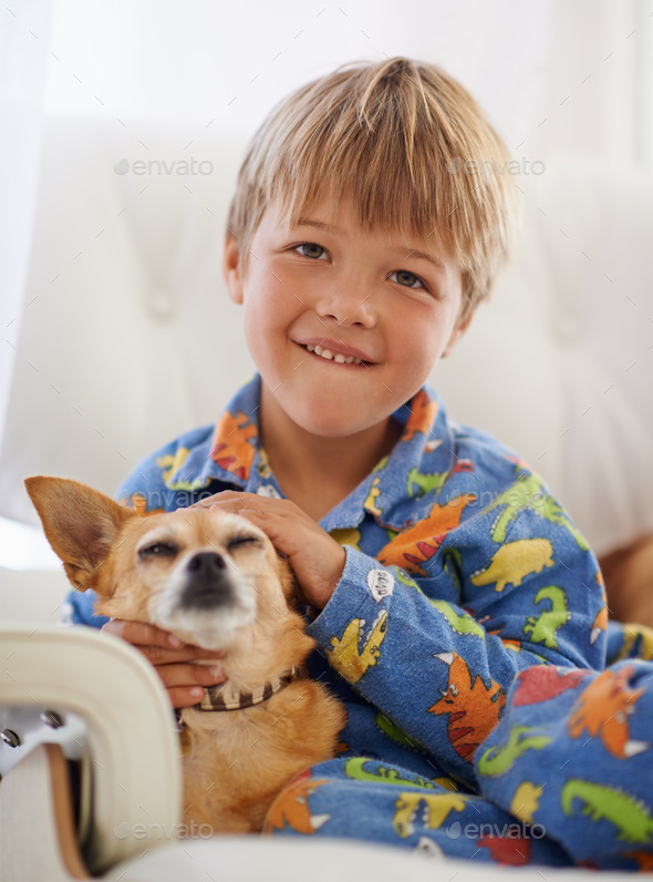 Snuggling his old friend. A cute little boy cuddling his dog on the ...