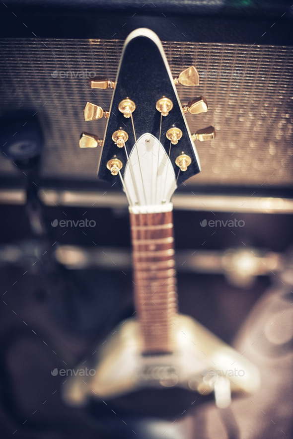 The guitar with the most sound. High angle view of a guitar leaning on an amp. - Stock Photo - Images