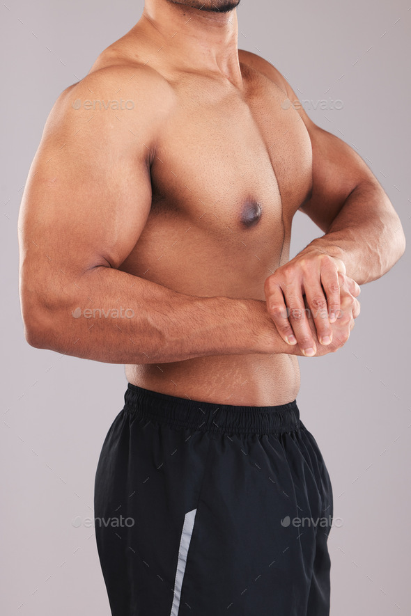Strong man, bodybuilder and flexing bicep on studio background for fitness,  wellness and topless sp Stock Photo by YuriArcursPeopleimages