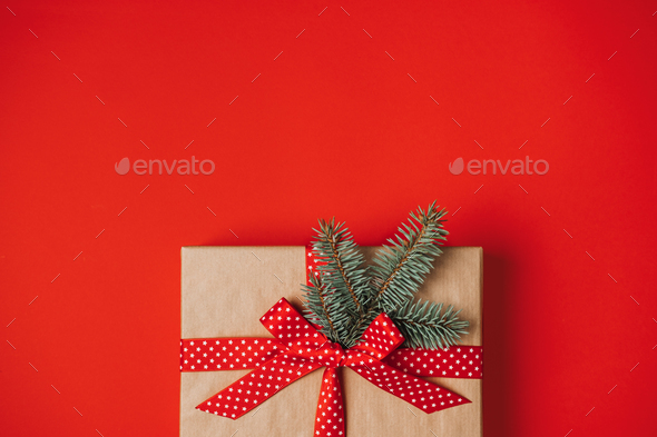 One Red luxury New Year gift box on red background. Christmas gift