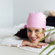 Smiling woman in a pink scarf at home - PhotoDune Item for Sale