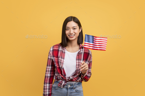 Education abroad, studying in the US, emigration concept. Happy asian female student holding