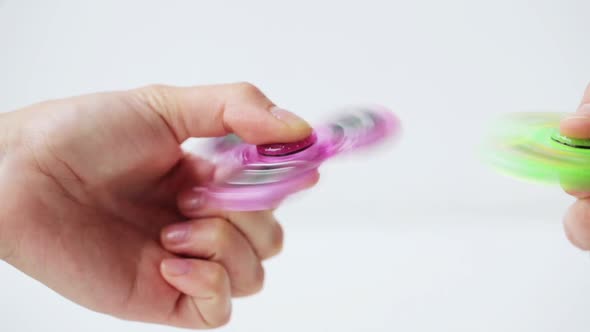 Hand Playing with Spinning Fidget Spinner  alt