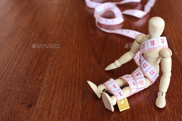 Wooden doll and measuring tape with copy space