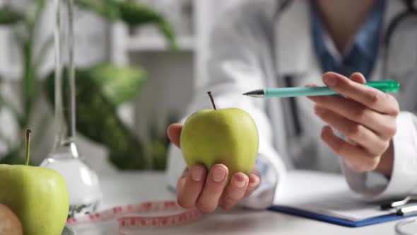 Doctor Explains The Usefulness And Benefits Of The Apple Fruit. Patient The Appointment With alt