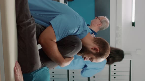 Vertical Video Physiotherapist Assisting Elder Patient with Physical Injury alt