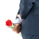 Businessman in suit  holding red roses behind his back - PhotoDune Item for Sale