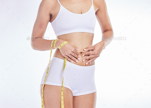 Weight loss, stomach and measure tape for body measurement for health,  wellness and healthy diet. F Stock Photo by YuriArcursPeopleimages