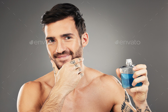 Man, perfume and cologne product in studio for hygiene, fresh scent and fragrance on gray backgroun