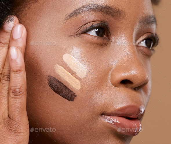 Beauty, makeup and foundation shades on face of black woman with swatch for cosmetics, diversity or