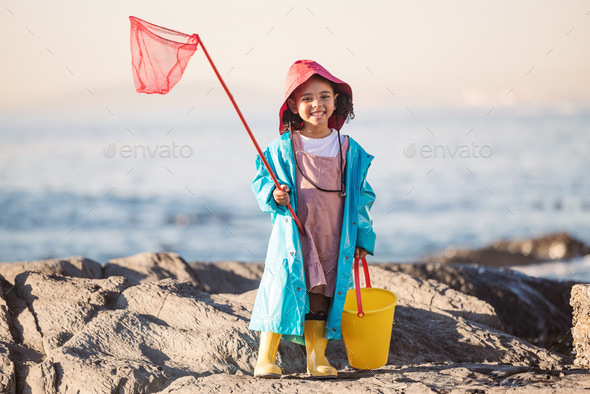 Child, kid or girl portrait with fishing net, bucket and net at