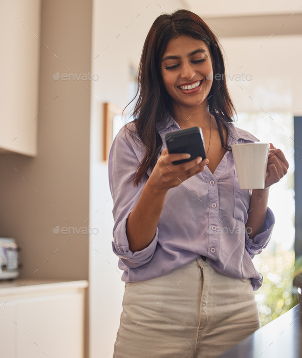 Woman, phone and smile with coffee for communication, chatting or social media in the kitchen at ho - Stock Photo - Images