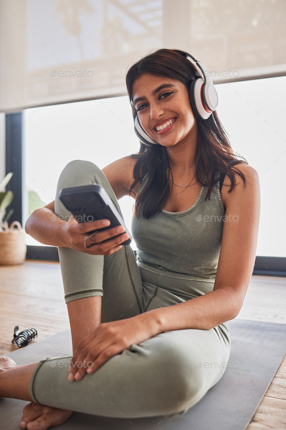 Yoga, headphones and smartphone woman with fitness music for wellness, motivation and body goals in