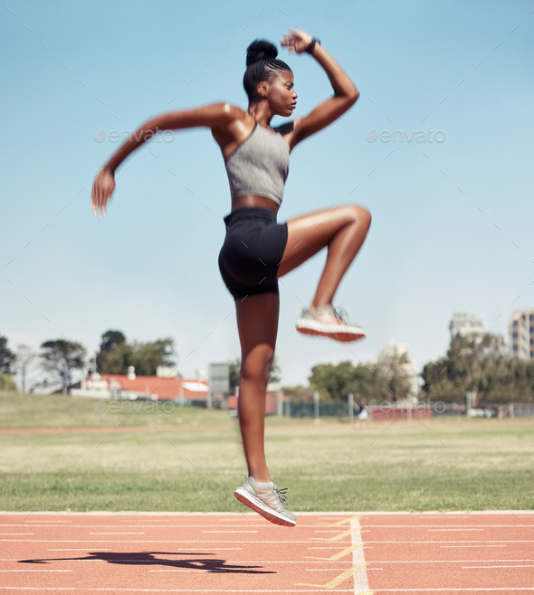 Fitness, jump or black woman runner on a race track in training, cardio workout or sports exercise