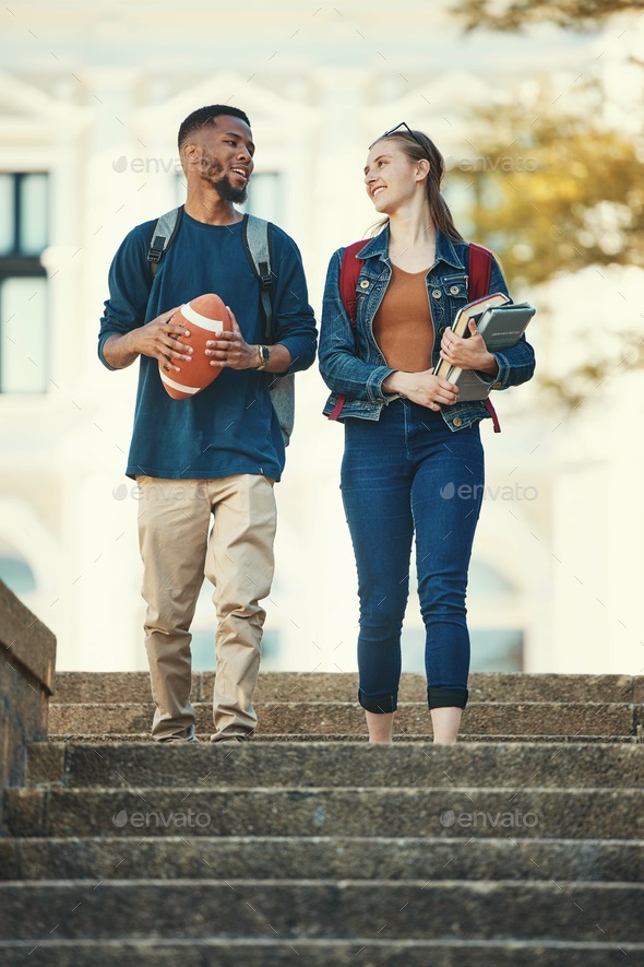Couple, friends or students walking in stairs of university, college or campus with books or footba