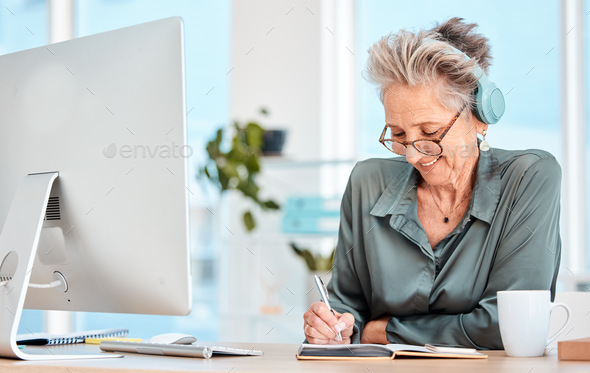 Senior woman, headphones and writing in office or happy planning motivation with notebook and music